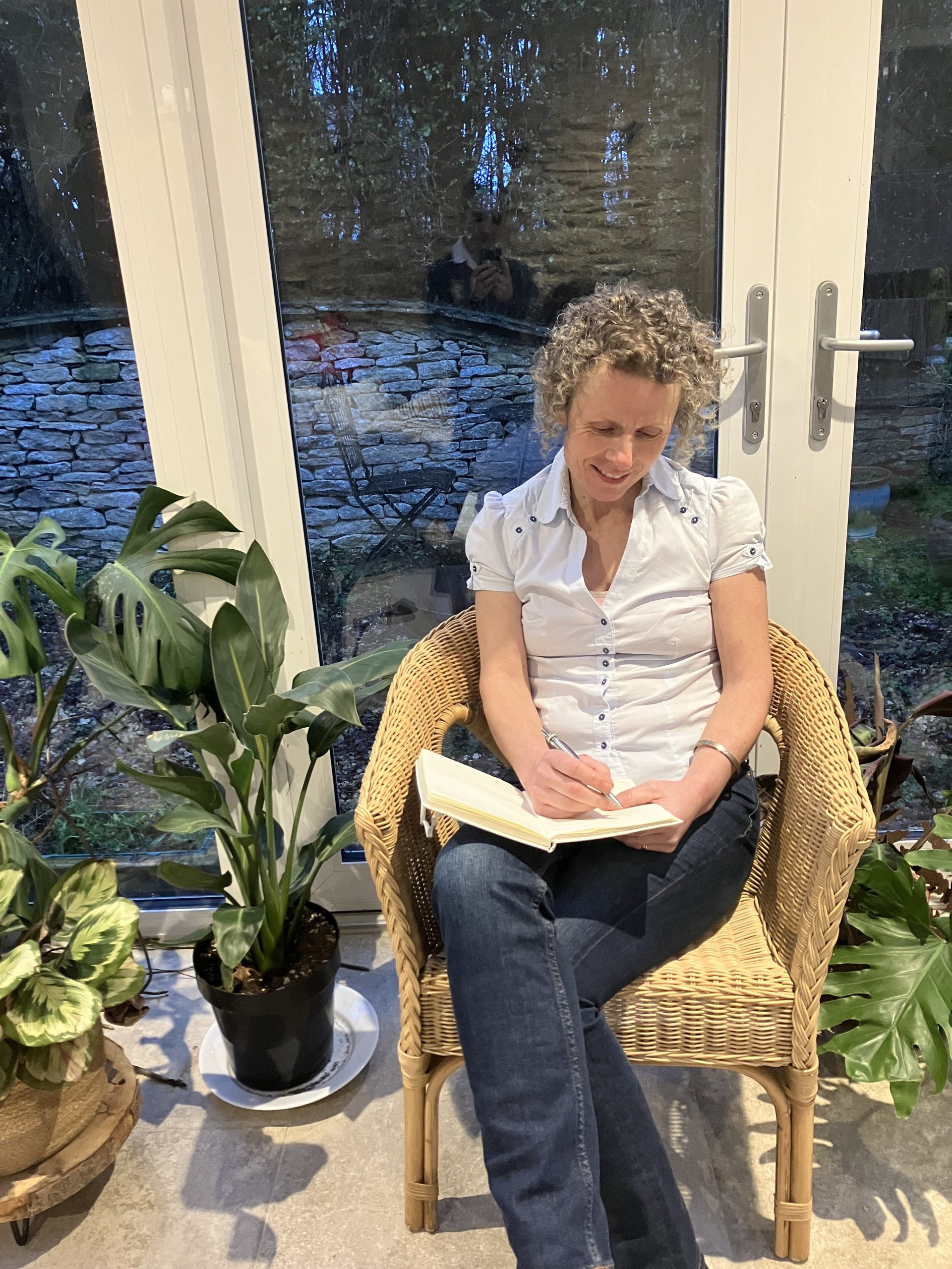 rachael seated in garden room
